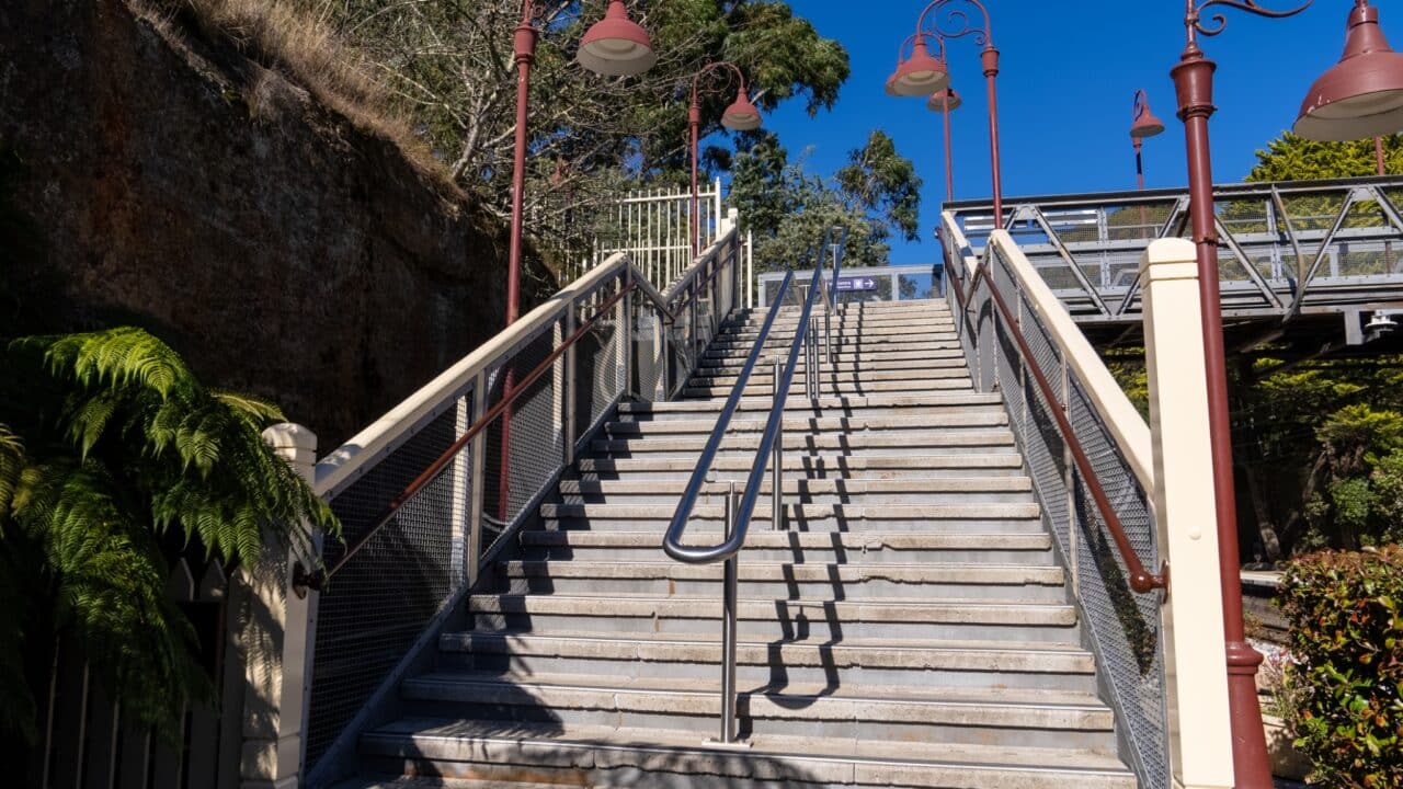 Stone staircase with metal railings, part of the recent restoration, leading up towards a platform