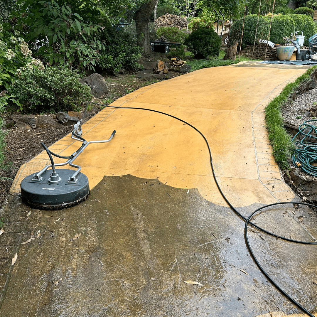 A concrete pathway in the Blue Mountains being cleaned using pressure cleaner