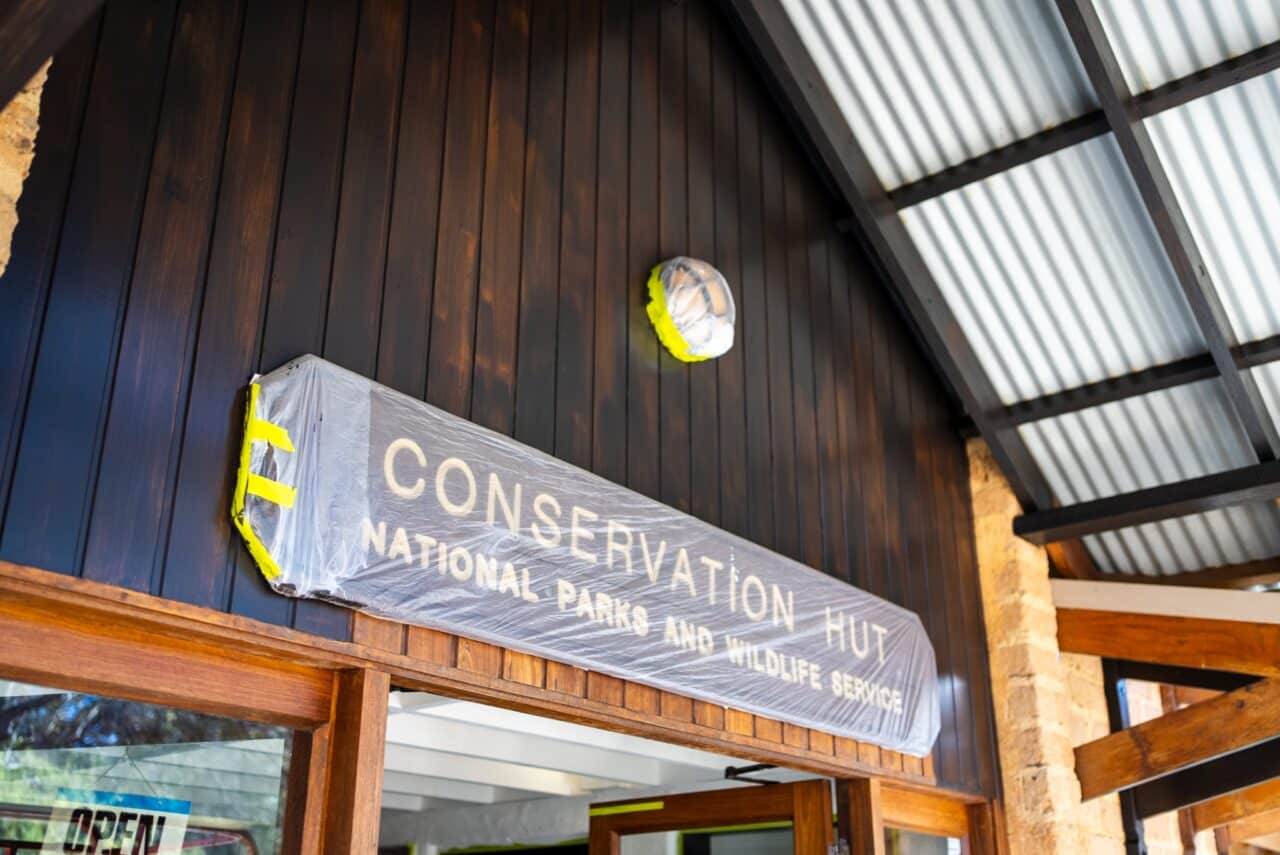 Entrance of a building with a sign "Conservation Hut, National Parks and Wildlife Service,"