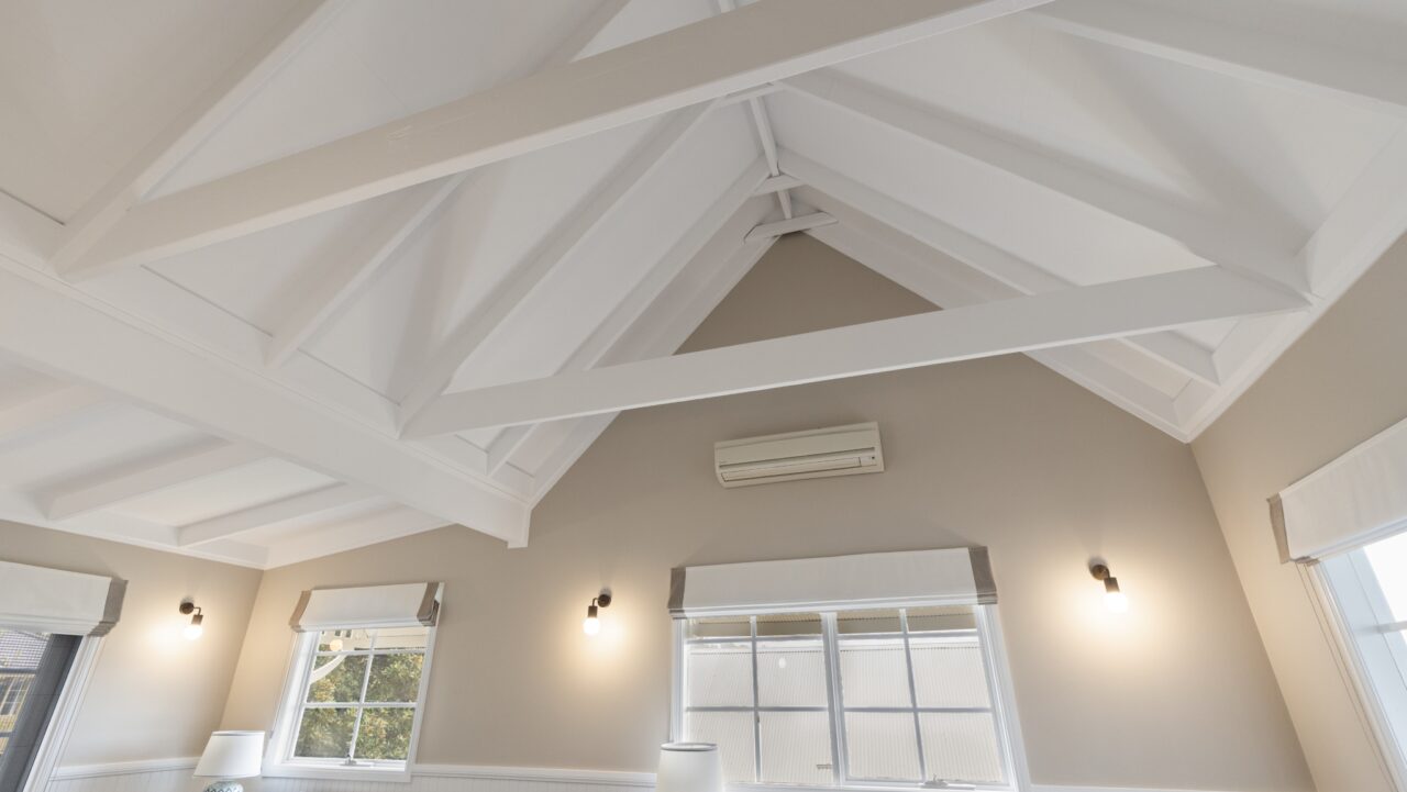 interior of a bullaburra house boasting a vaulted ceiling adorned with white beams