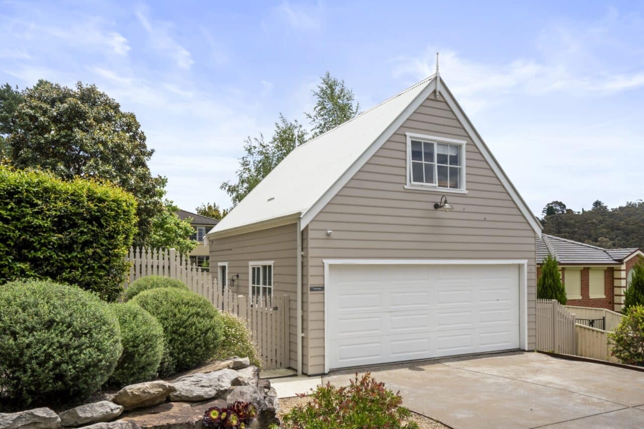 bullaburra house in a charming beige color and white garage door