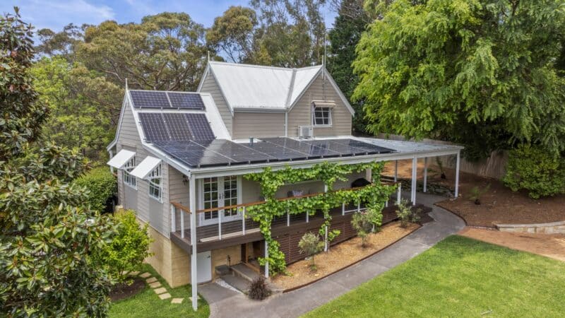 charming two-story residence featuring solar panels on the roof