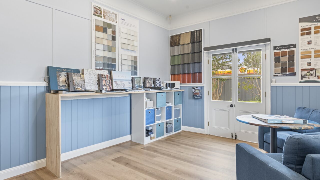 Bullaburra house room featuring blue walls with shelves full of fabric and material samples.
