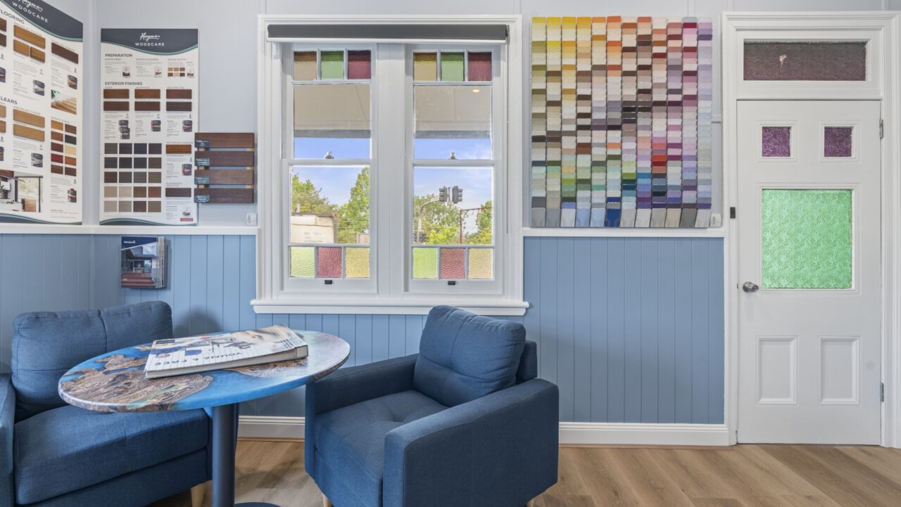 bullaburra house in a room with blue walls showcasing two dark blue armchairs