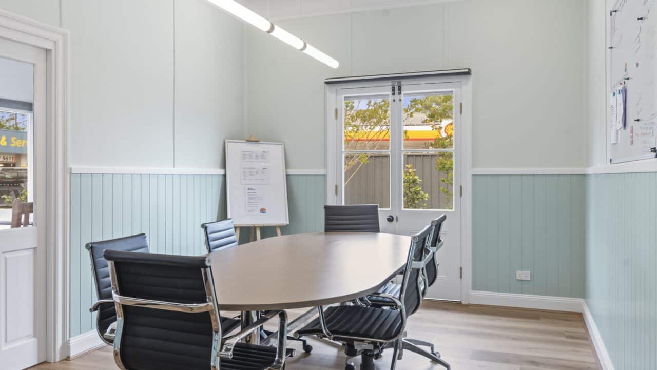 a meeting room at bullaburra house featuring a round table and six black chairs