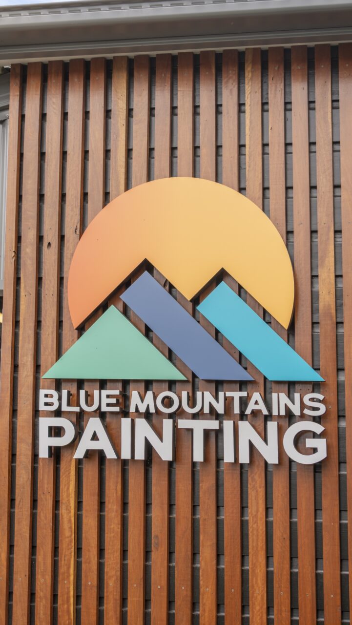 logo for "blue mountains painting" featuring stylised blue and teal mountains