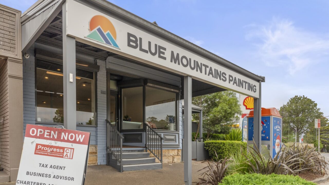 street view of blue mountains painting storefront with a sign reading "open now"