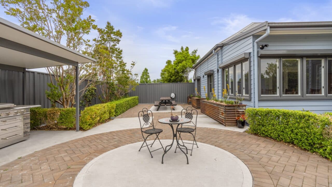 backyard patio at bullaburra house includes a circular paved area with a cozy round table