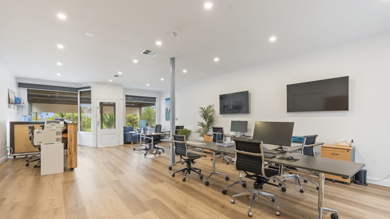 modern bullaburra house office with desks, chairs & computers, with two large wall-mounted screens