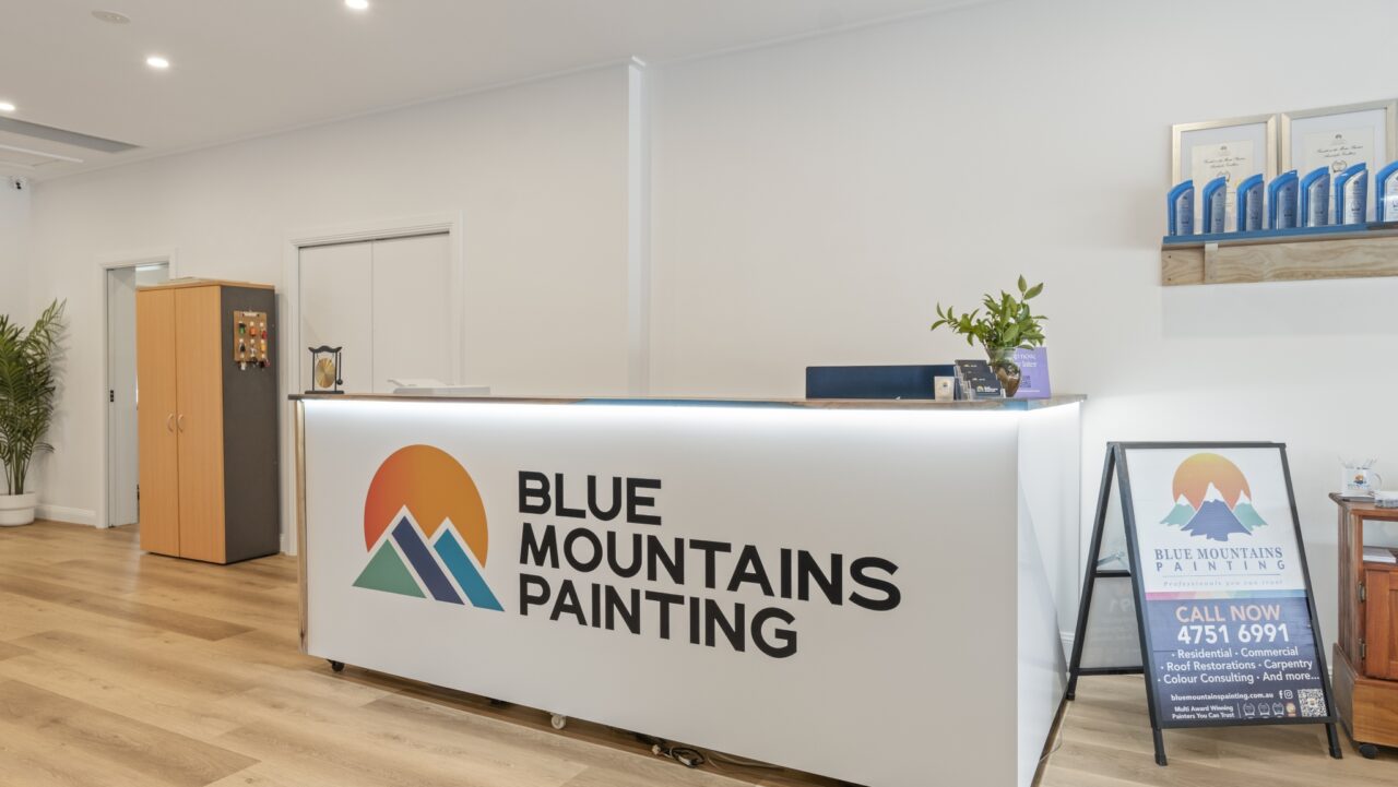 the reception area of blue mountains painting in bullaburra featuring a branded front desk