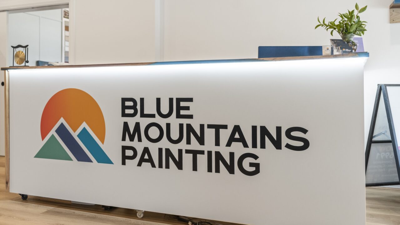 reception desk with a logo for "blue mountains painting"